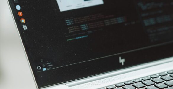 Student working on a laptop with code on the screen