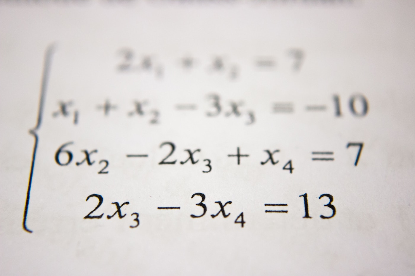 A student working through math problems on a classroom whiteboard