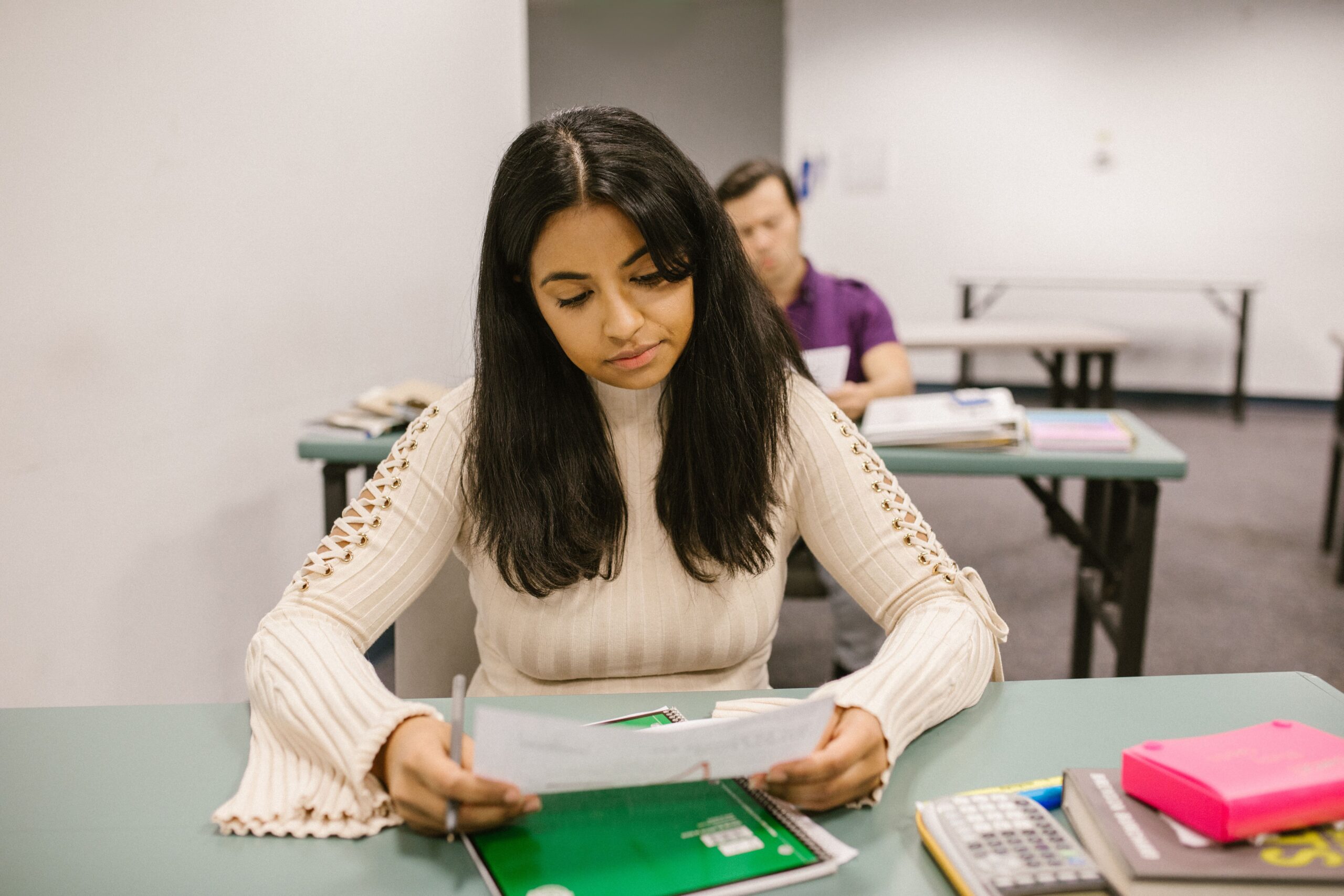 A student reviews test results, where one unusually high or low score may not show the whole pattern.