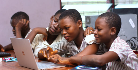 Students working together on a laptop for digital study