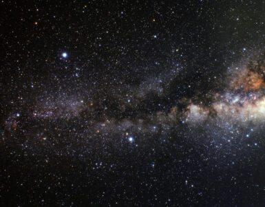 A wide-field night sky view showing the Summer Triangle formed by Vega, Deneb, and Altair.