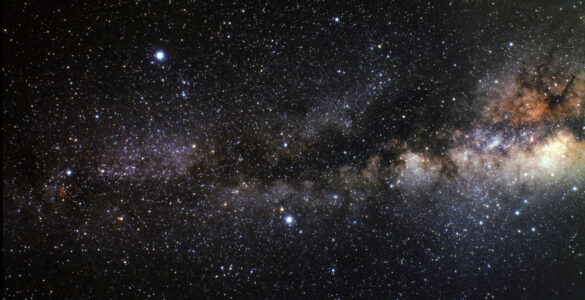 A wide-field night sky view showing the Summer Triangle formed by Vega, Deneb, and Altair.