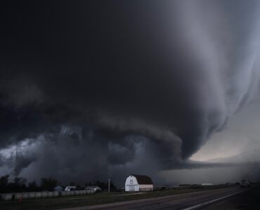 A large supercell thunderstorm rising over open land, where strong updrafts can help hailstones grow.