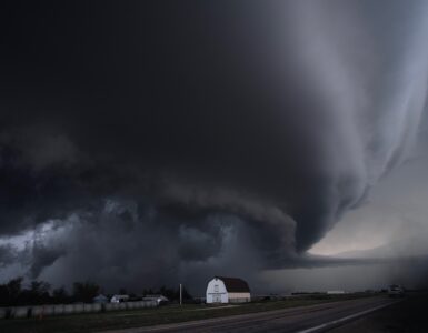 A large supercell thunderstorm rising over open land, where strong updrafts can help hailstones grow.
