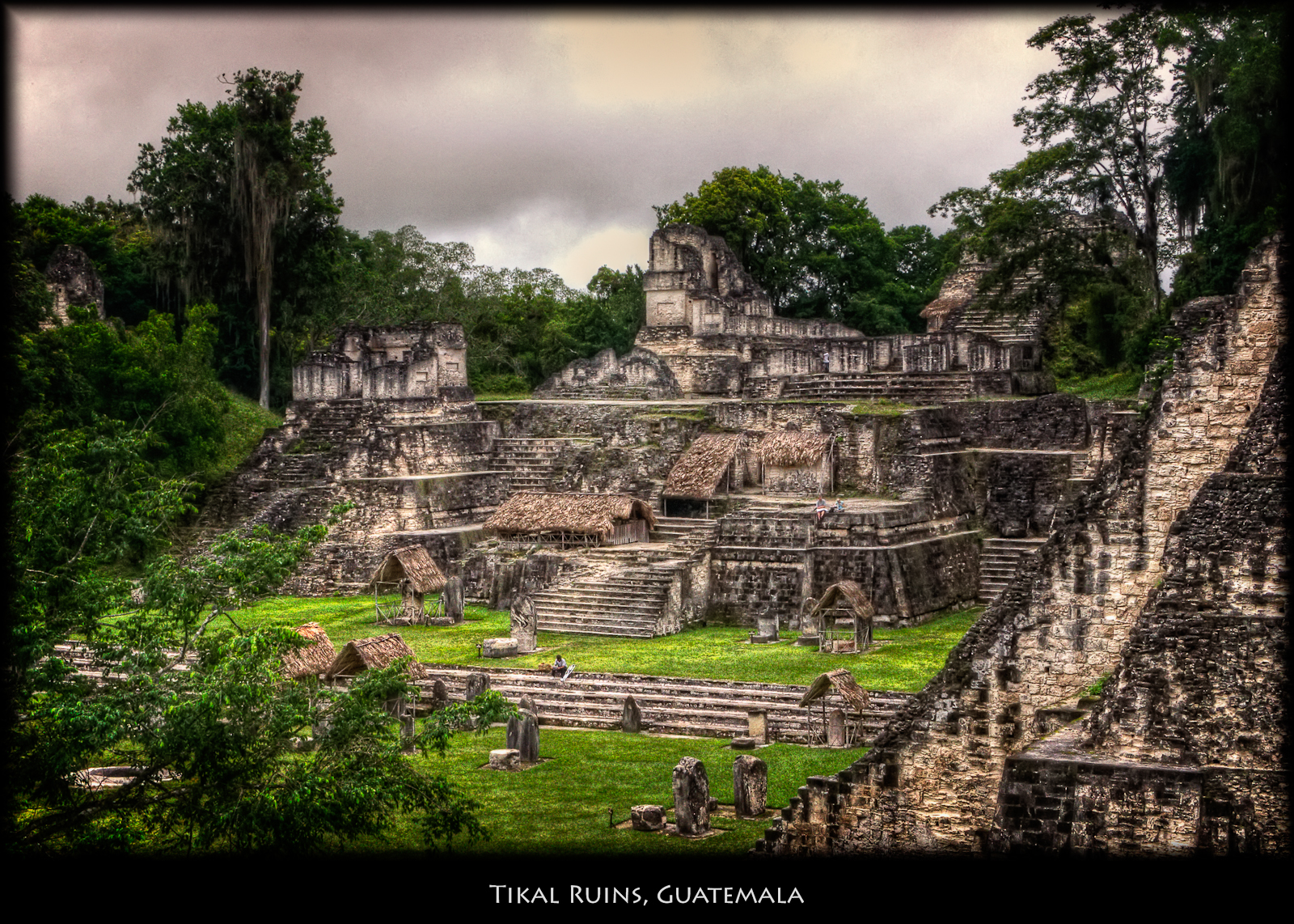 Maya stone ruins at Tikal surrounded by tropical vegetation