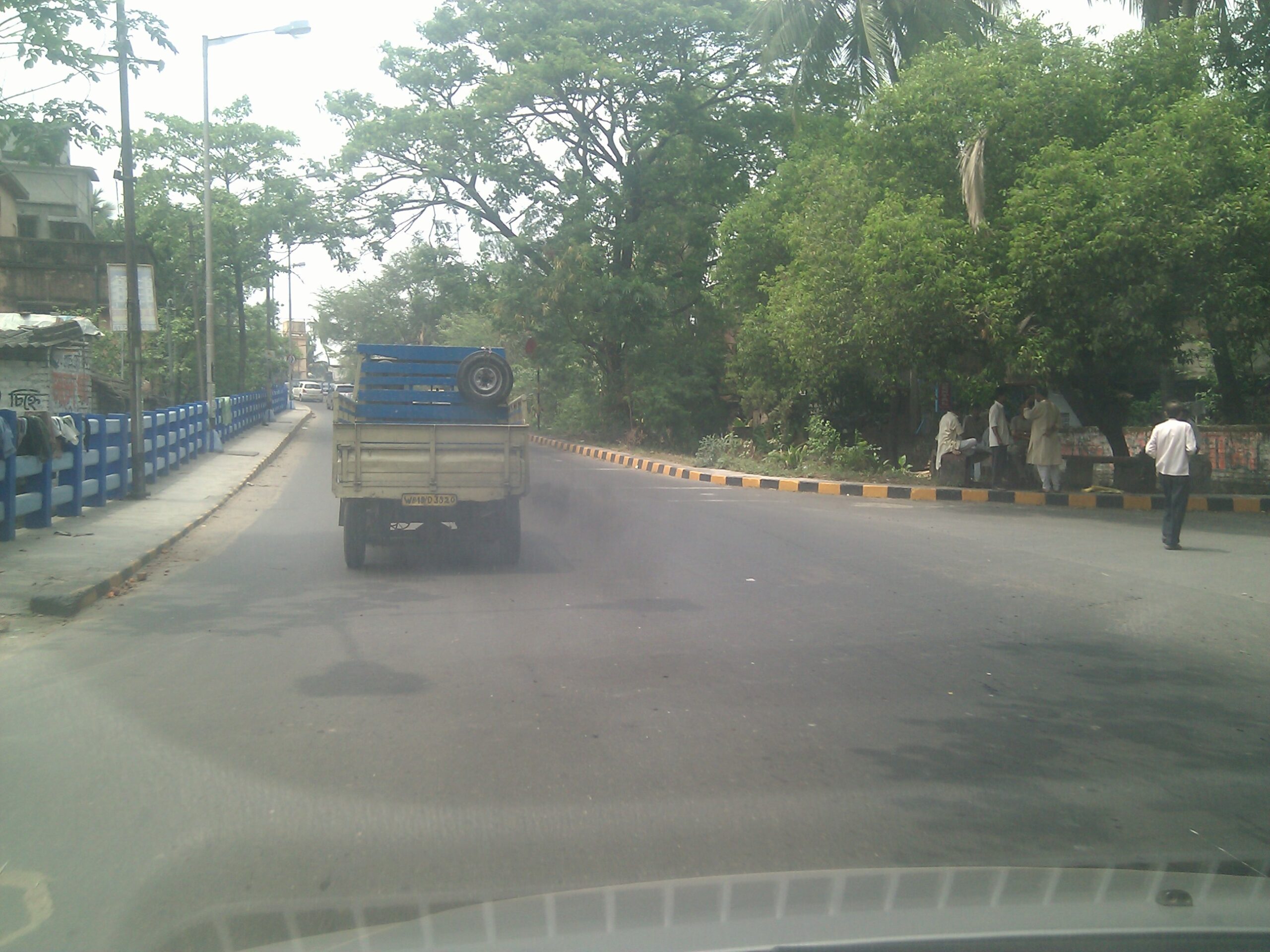 Traffic on a city street with visible exhaust pollution