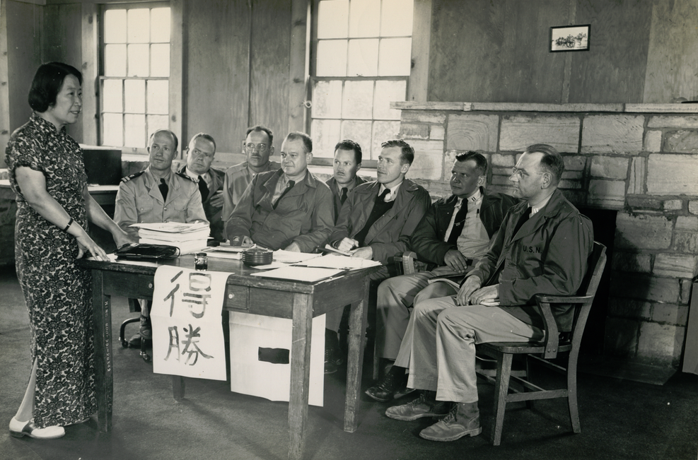 Students in a language classroom with Chinese characters on the board, showing why digital systems need many writing systems