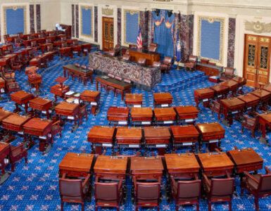 The United States Senate chamber with rows of desks arranged around the presiding officer's desk.