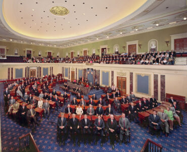 The United States Senate chamber during a formal session with senators seated at desks.