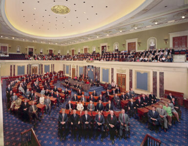 The United States Senate chamber during a formal session with senators seated at desks.