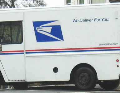 A USPS delivery truck on a residential street, representing how ZIP Codes connect addresses to delivery routes