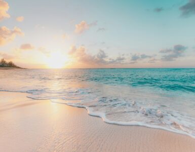 Bright sunlight over a sandy beach and ocean