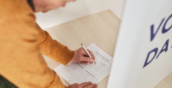 A voter marking a paper ballot at a polling station