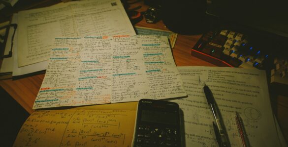 A calculator and handwritten algebra notes used while solving absolute value equations.
