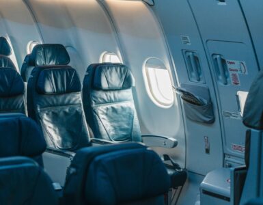 Rows of passenger seats inside a pressurized airplane cabin during flight.