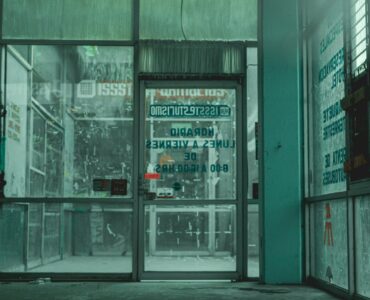 Glass automatic doors at a store entrance where sensors can detect someone approaching.