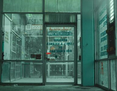 Glass automatic doors at a store entrance where sensors can detect someone approaching.