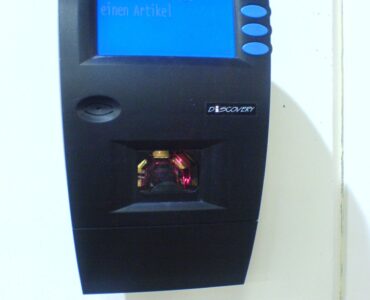 A supermarket barcode scanner used to read product codes from packages.