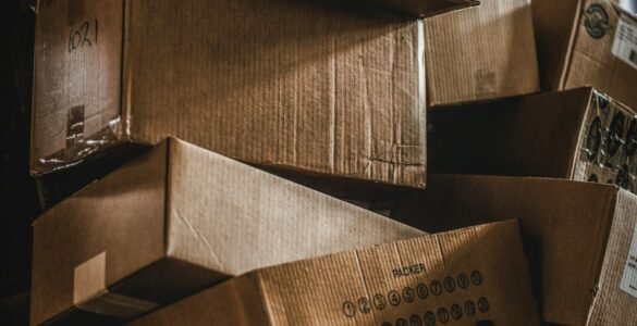 Stacks of cardboard boxes in a warehouse, representing how inventory decisions can grow as demand signals move through a supply chain.