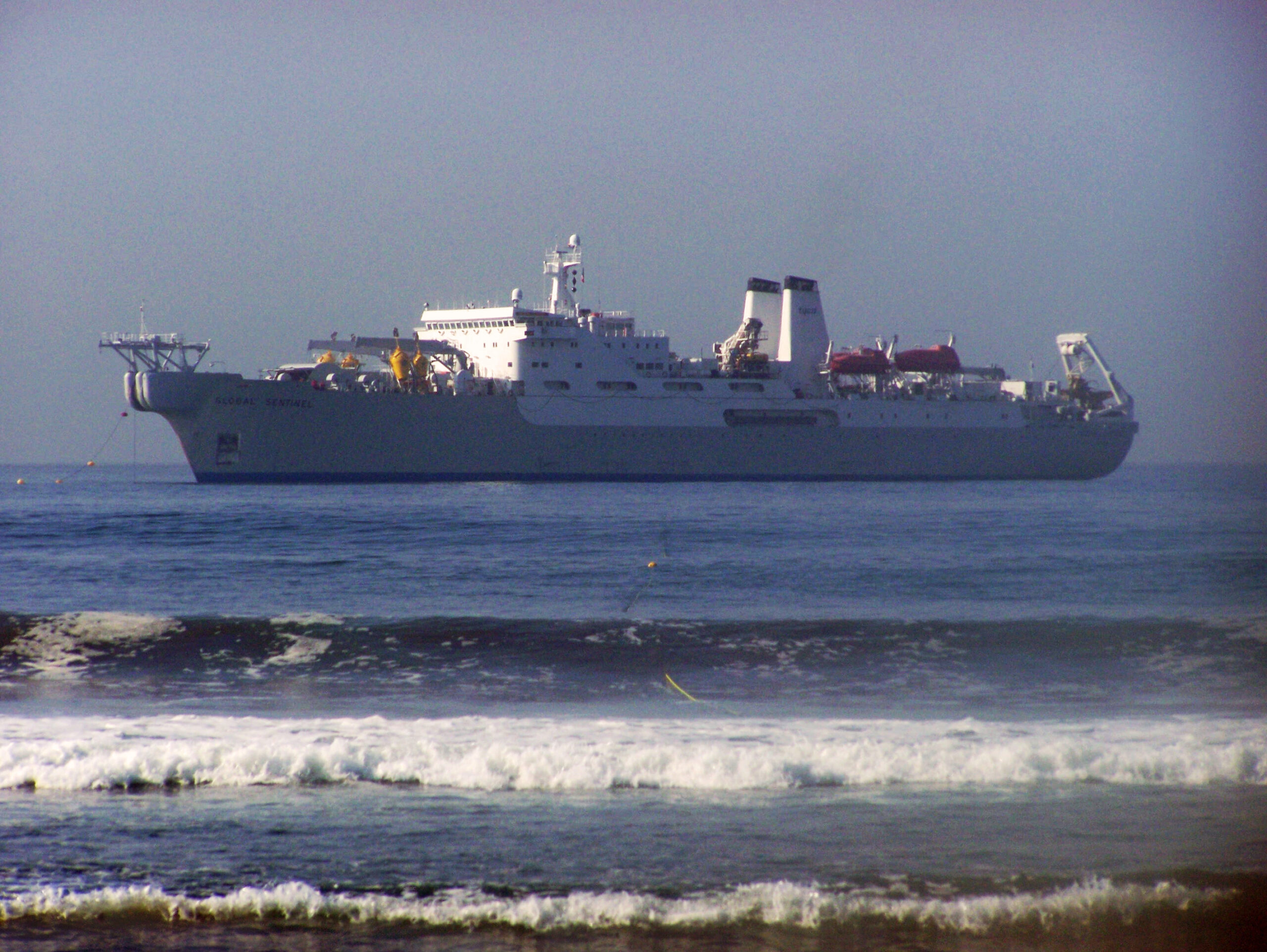 A cable ship at sea laying or maintaining submarine communications cable.