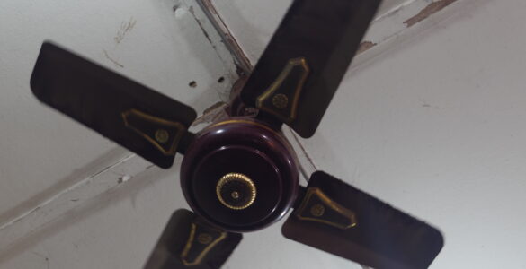 A four-blade ceiling fan mounted above an indoor room