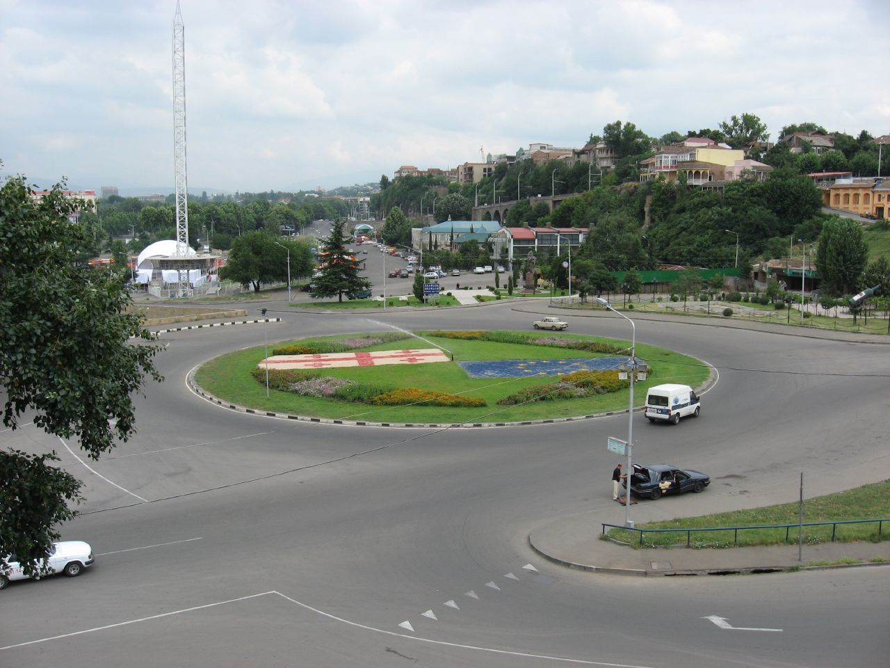 City roundabout with vehicles moving around a central island.