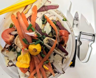 Vegetable peels and food scraps collected as organic material for composting.