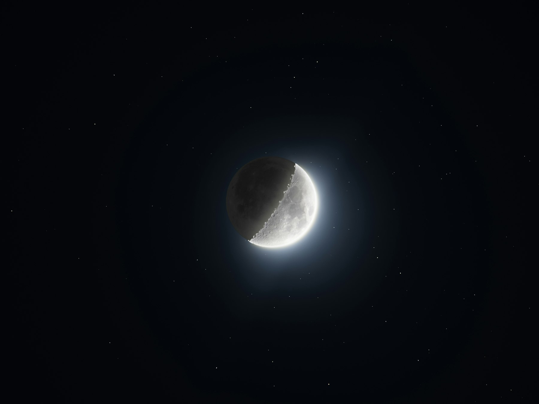 A bright crescent moon glowing in a dark starry sky