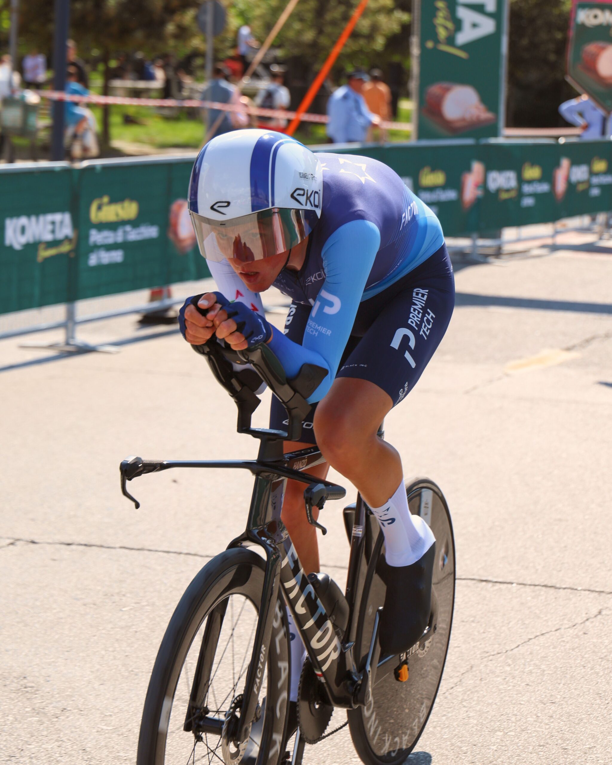 A road cyclist riding alone in an aerodynamic time trial position