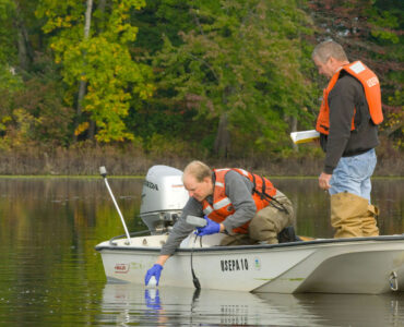 Scientists collect water samples that can be tested for environmental DNA from nearby species