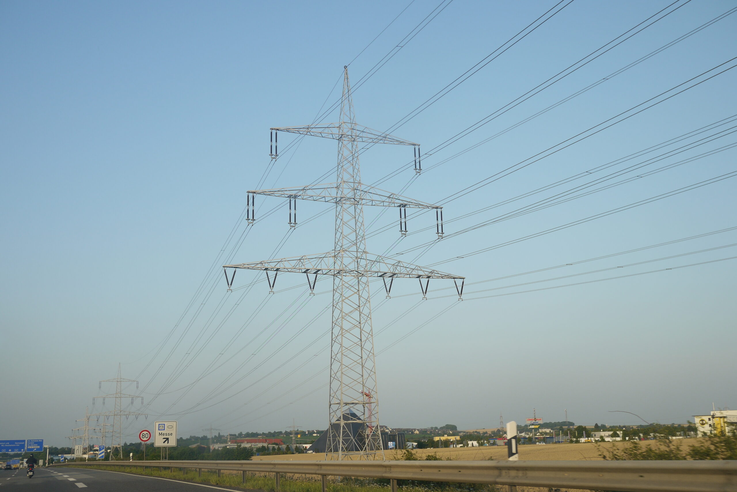 High-voltage transmission lines carrying electricity across the power grid.
