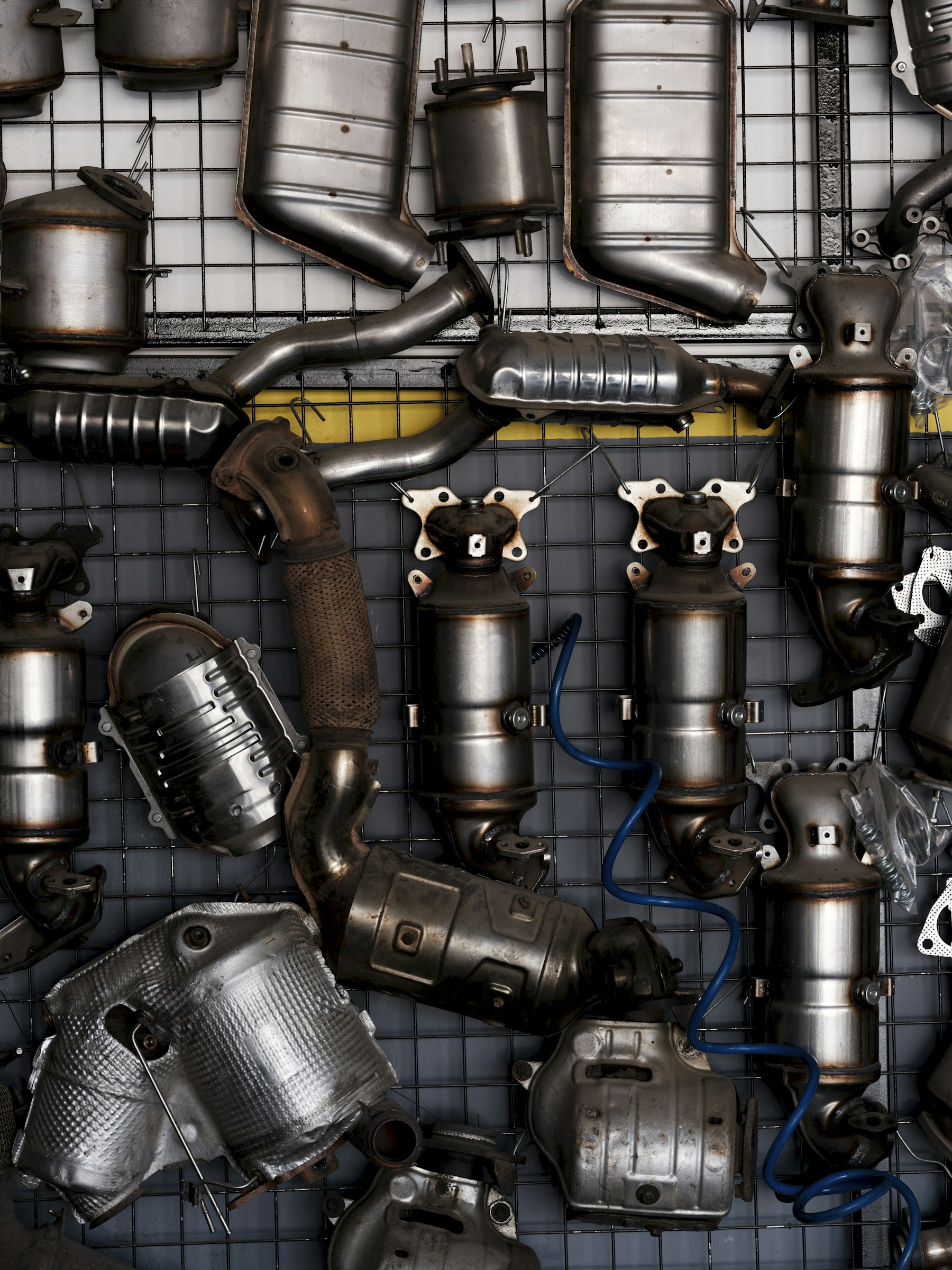 Automotive exhaust system parts and catalytic converters showing the metal housings that clean engine gases.