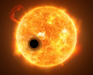 Artist concept of an exoplanet crossing in front of a bright star during a transit.