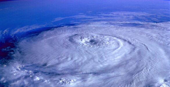 A satellite view of a rotating hurricane, useful for understanding how nearby tropical cyclones can interact.