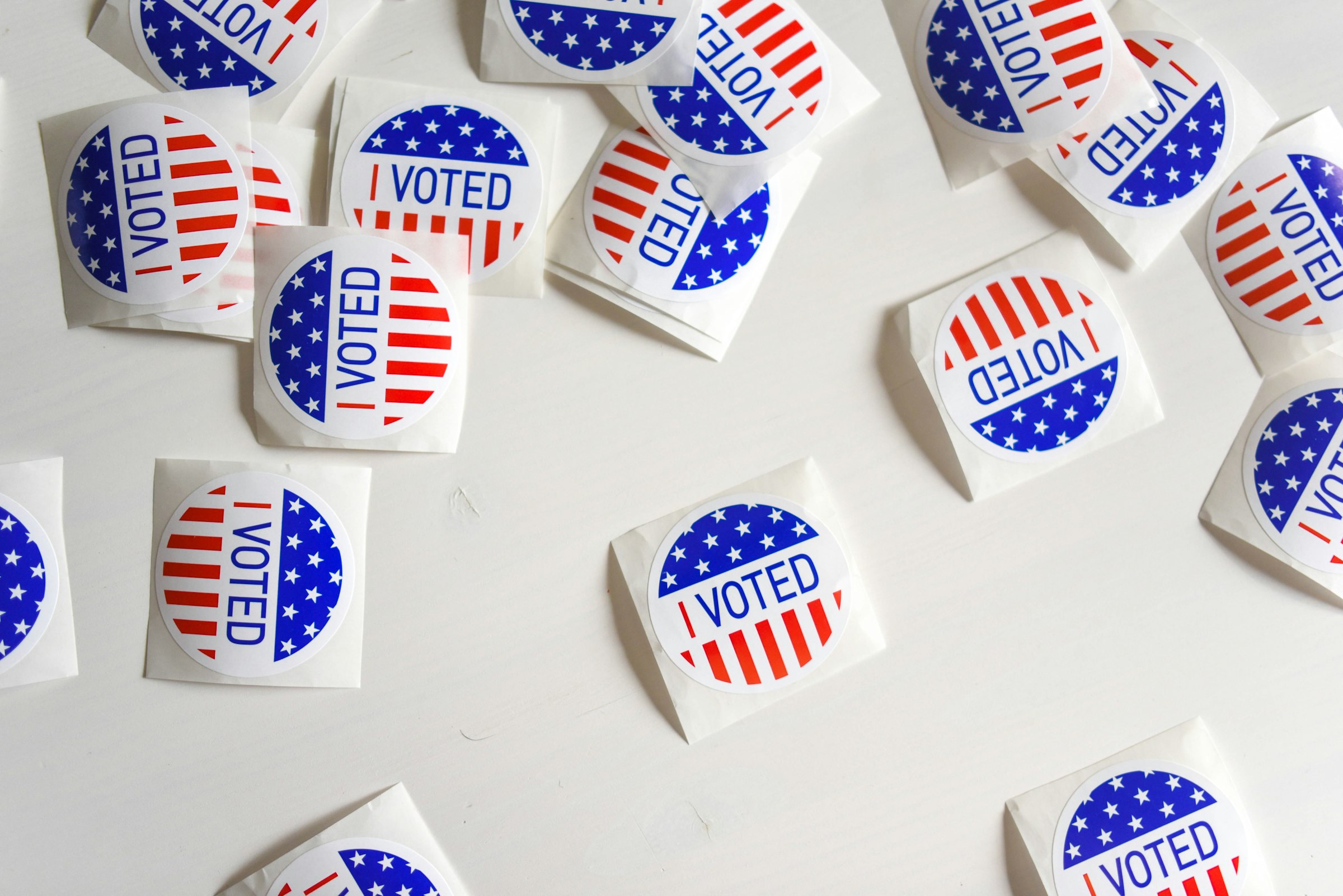Several I Voted stickers spread across a white table