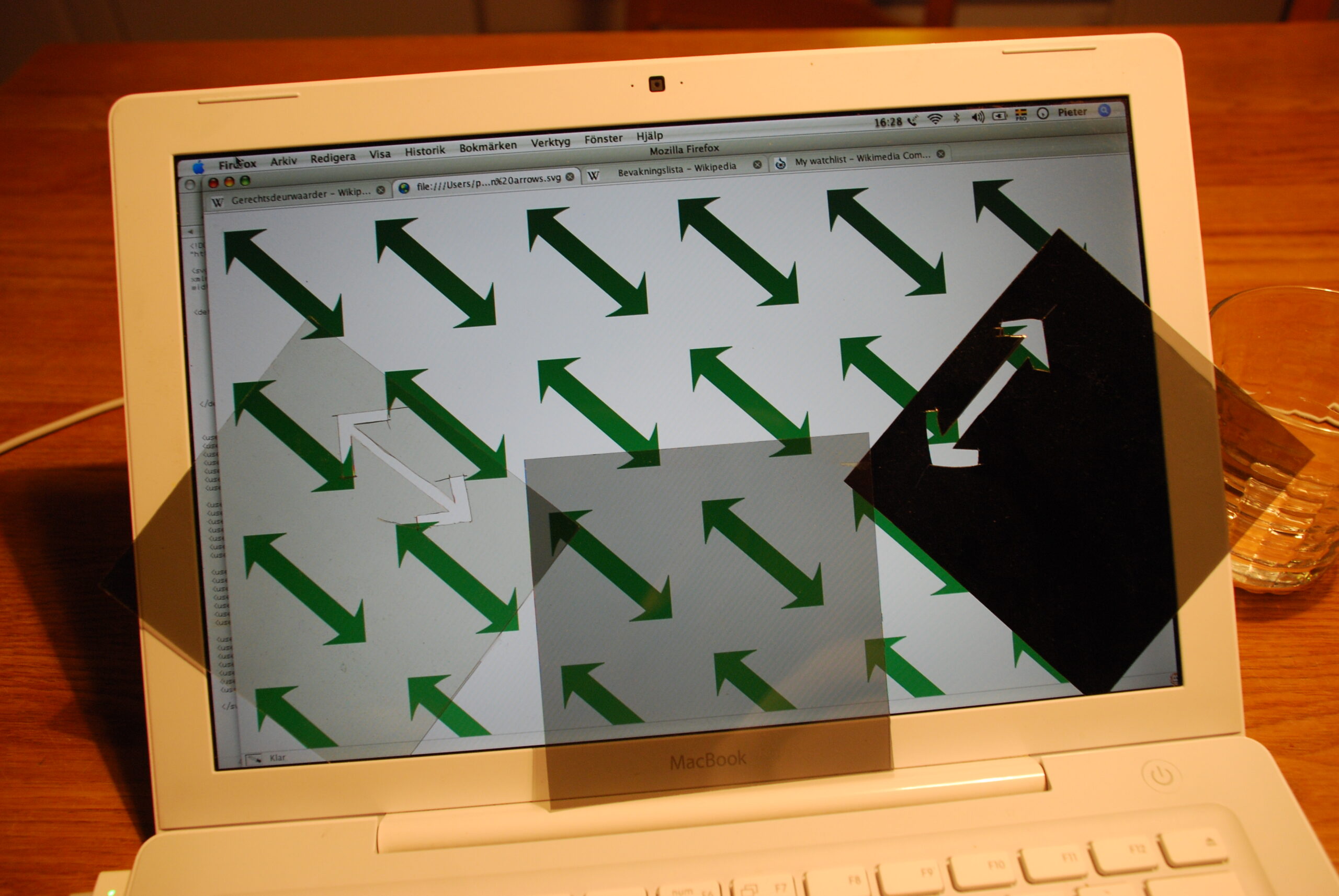 Polarizing sheets over a laptop LCD screen showing bright and dark light patterns