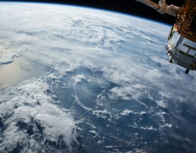 A satellite above Earth representing communication and navigation systems that depend on precise signals