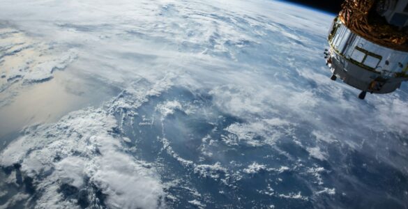 A satellite above Earth representing communication and navigation systems that depend on precise signals