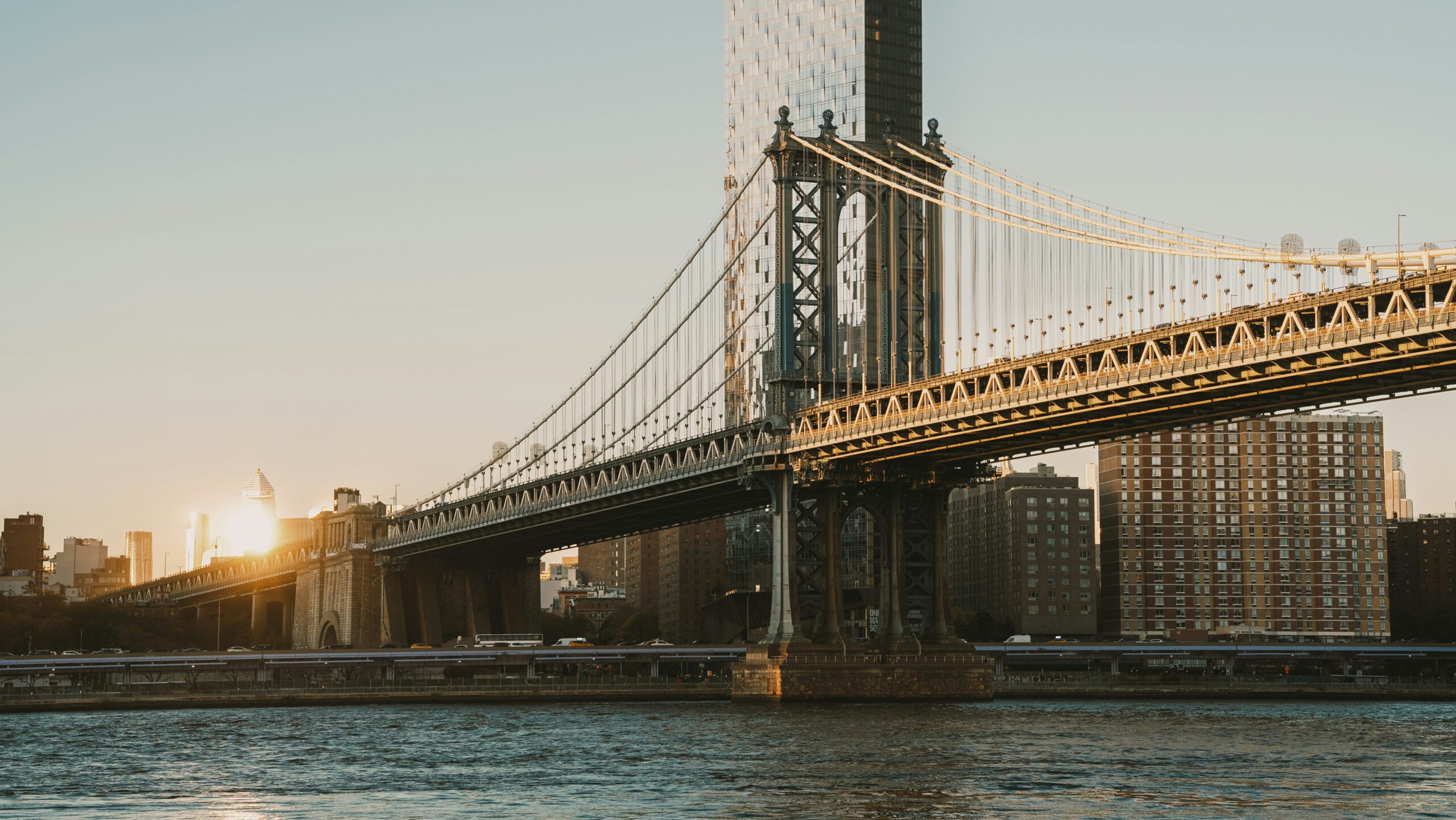 The Manhattan Bridge and nearby buildings lit by low sunset light