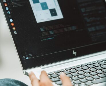 A student working on a laptop, representing the connection between linear algebra and computer graphics.