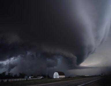 A large thunderstorm over open land where powerful downdrafts can produce damaging microburst winds.