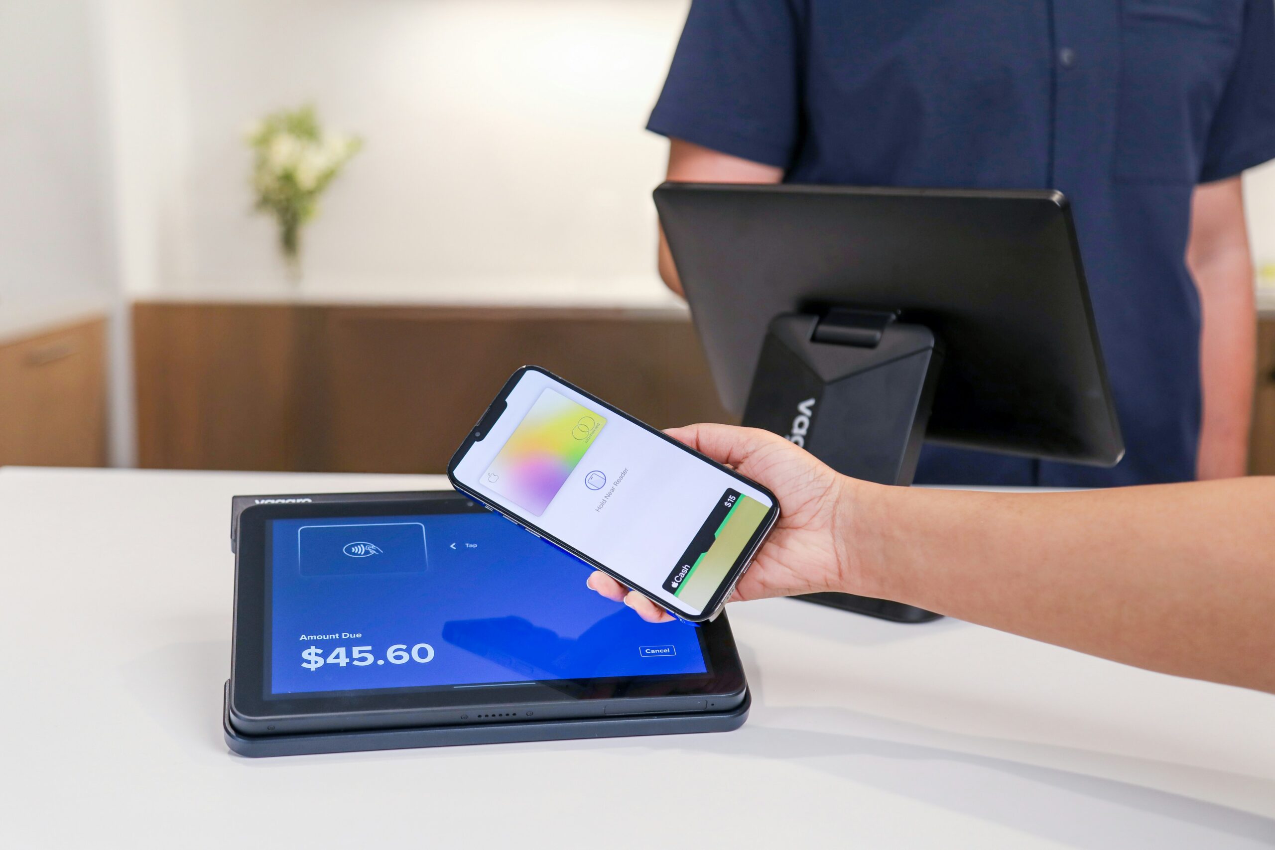 A mobile payment terminal showing a purchase amount, representing transactions that can affect a checking balance