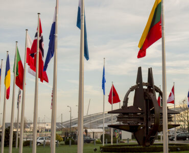 NATO member-country flags waving outside the alliance headquarters in Brussels