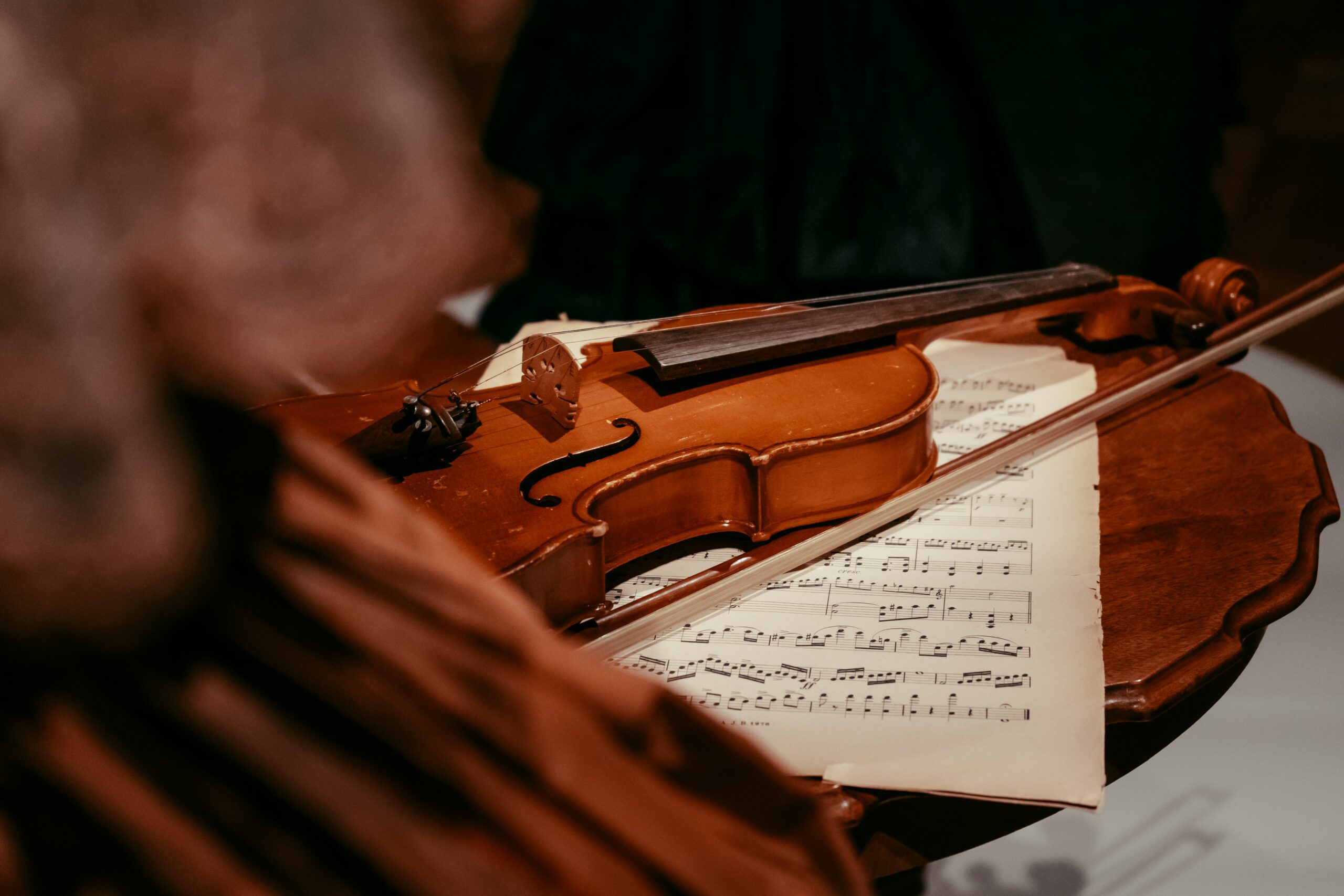A string instrument close up, representing musicians adjusting pitch before playing together.