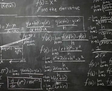 Calculus equations on a blackboard for thinking about partial derivatives and multivariable change