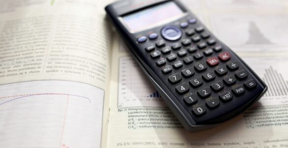 A calculator on an open math textbook used while practicing combinations and counting patterns.