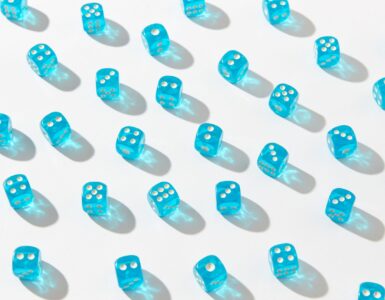 Blue dice arranged on a white surface to represent branching probability outcomes.