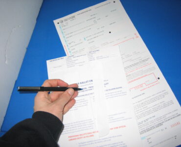 A provisional ballot envelope being handled at a polling place