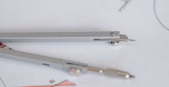 A compass and ruler on a geometry diagram, suggesting angle relationships used in right-triangle trigonometry.