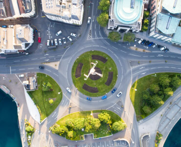 Aerial view of cars moving through a modern roundabout.